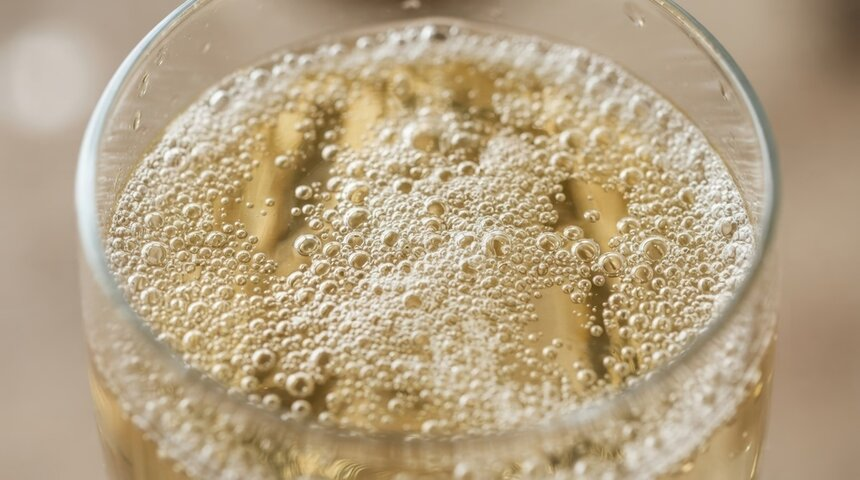 Close-up of sparkling wine bubbles in a glass